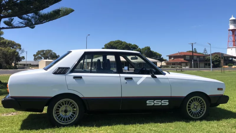 Datsun Stanza SSS Sedan white on black Australia 2021 (1).png