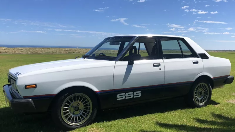 Datsun Stanza SSS Sedan white on black Australia 2021 (2).png