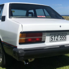 Datsun Stanza SSS Sedan white on black Australia 2021 (4).png